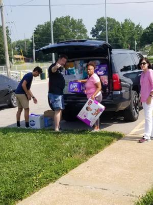 Volunteers help to pack and deliver diapers to the diaper bank for sorting. 